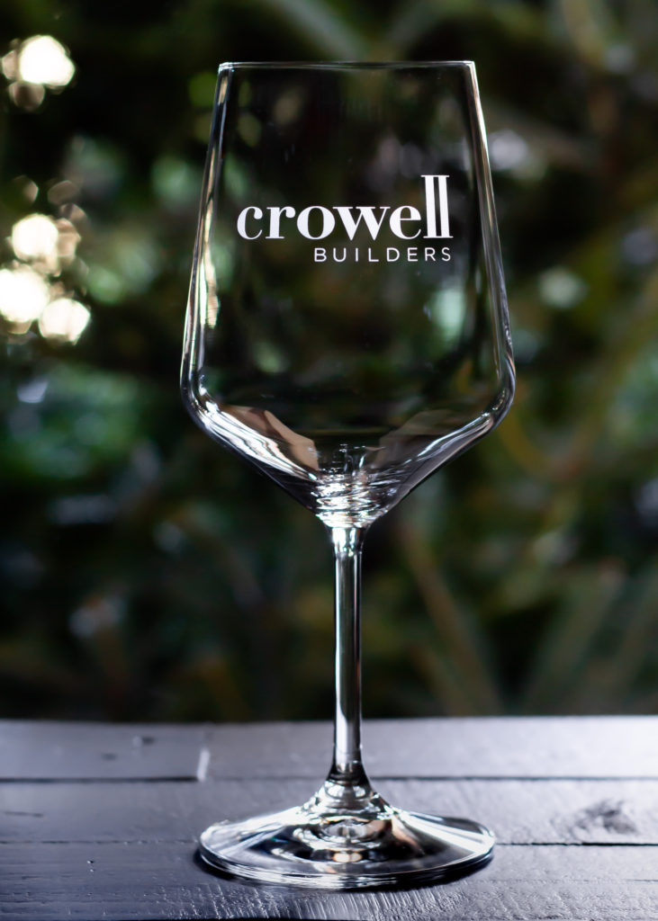 Etched engraved wine glass with Crowell Builders Logo